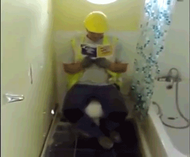 builder-sitting-on-toilet-hand-pulls-through-wall-13905888040.gif